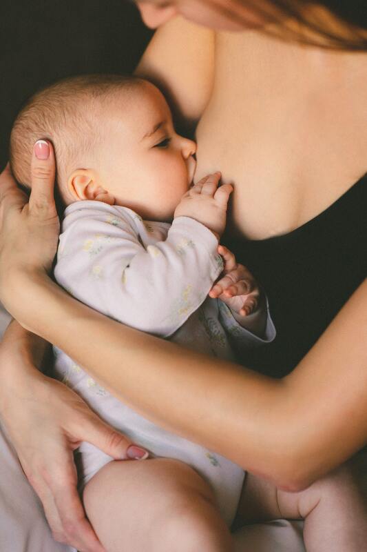 woman breastfeeding an infant